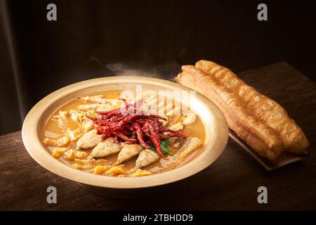 Stewed Carp fish head in Brown Sauce served with Deep Fried Dough Stick Stock Photo