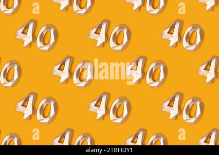 Repetitive pattern made of golden number 40 on a yellow background. Stock Photo