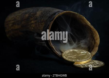 A cornucopia with golden coins against a dark background. Ripple, cryptocurrency Stock Photo