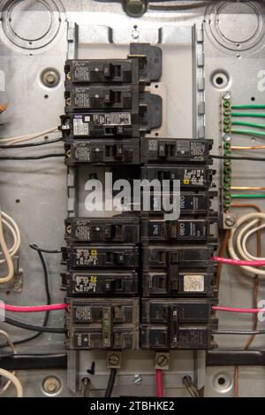 An electrical control panel featuring several switches and wiring Stock Photo