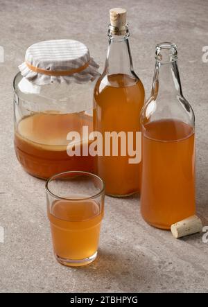 Jar, bottle and glass with Kombucha drink close up Stock Photo