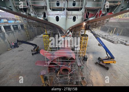 (231207) -- NANJING, Dec. 7, 2023 (Xinhua) -- Workers work at a shipyard of Jiangsu Yangzi Xinfu Shipbuilding Co., Ltd. in Taixing, east China's Jiangsu Province, Dec. 5, 2023. In the first 10 months of 2023, China has maintained its top position in the global shipbuilding market with strong growth in both output and new orders, industry data showed. The country's shipbuilding output climbed 12 percent year on year to 34.56 million deadweight tonnes (dwt) during the January-October period, accounting for 49.7 percent of the world's total, according to data from the China Association of the Stock Photo