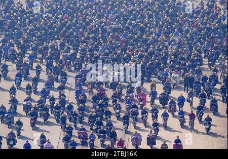 (231207) -- NANJING, Dec. 7, 2023 (Xinhua) -- This aerial photo taken on Dec. 5, 2023 shows workers riding to leave a shipyard of Jiangsu Yangzi Xinfu Shipbuilding Co., Ltd. in Taixing, east China's Jiangsu Province.  In the first 10 months of 2023, China has maintained its top position in the global shipbuilding market with strong growth in both output and new orders, industry data showed.   The country's shipbuilding output climbed 12 percent year on year to 34.56 million deadweight tonnes (dwt) during the January-October period, accounting for 49.7 percent of the world's total, according to Stock Photo