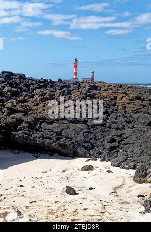 Natural tidal pools of The Playa de los Charcos beach and The Toston Lighthouse - Natural Pools of Los Laguitos Beach or Los Charcos on Fuerteventura, Stock Photo