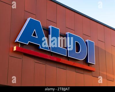 ALDI logo sign of the German food discounter store. Close up of the logotype on the facade. The grocery retailer is a very successful business. Stock Photo