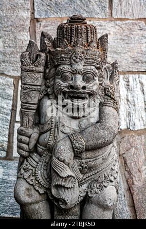 Traditional Balinese temple guardian carved stone statue Stock Photo