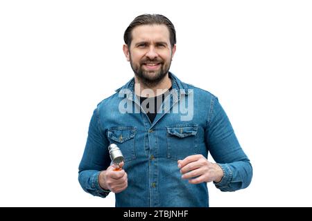 Portrait of young mechanic looking relaxed at the camera with a socket wrench in his hand. Stock Photo