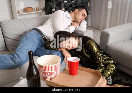 Drunk young people sleeping after New Year party at home Stock Photo