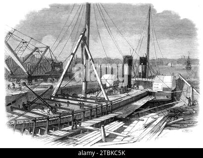 Laird's Graving Docks at Birkenhead: the Hibernia under repair, 1861. 'At the Birkenhead Ironworks the first vessels for the United States of America, for the River Indus, for the Nile, Euphrates, Tigris, and other important rivers of the East, were built. The first steam-frigate ever constructed for the Admiralty was also built there...from 1829 up to this time nearly three hundred vessels, of a total gross tonnage of upwards of 100,000 tons, have been constructed at the above establishment. There are now from two to three thousand men employed there, a large number of vessels being in course Stock Photo