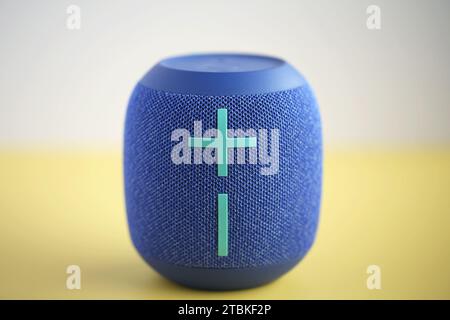 Digital Wireless Sound Speaker on yellow and gray background. Stock Photo