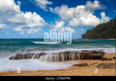 An isolated tropical quiet beach on the Pacific island of Kauai, Hawaii, USA. Stock Photo