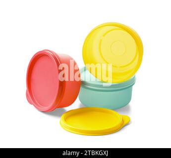 Multi-colored plastic food containers with sealed lids on a white background. Eco-plastic utensils for long-term food storage. Stock Photo