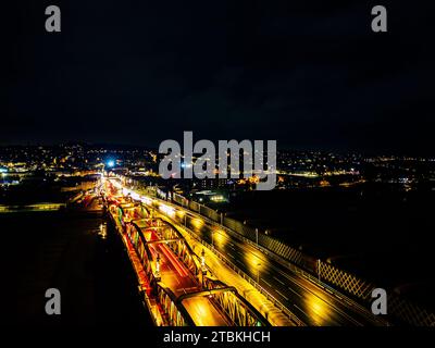 Rochested bridge illuminated at night. The aerial photograph was taken by a drone. Stock Photo