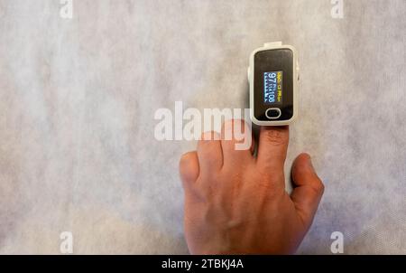 hand using an oximeter on a white background Stock Photo