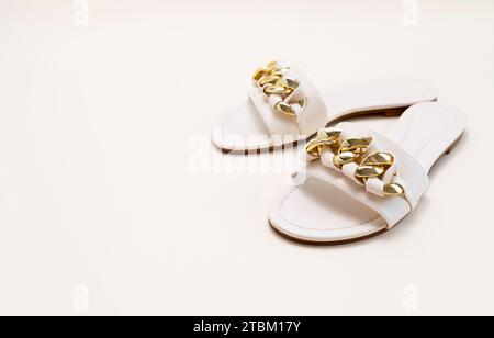 Mockup White Beige Female Eco-leather Sandals With Golden Buckle Chain. Fashion, Summer Footwear, Shoes For Woman. National Shoe The World Day. Pastel Stock Photo