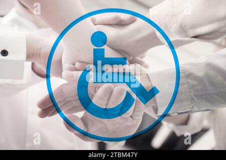 Inclusive workplace culture. International symbol of access. People holding hands together, closeup Stock Photo