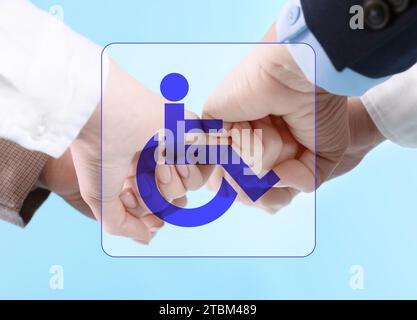 Inclusive workplace culture. International symbol of access. People holding hands together, closeup Stock Photo