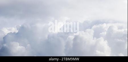 Cloudy sky background with sunlight shining through the white clouds Stock Photo