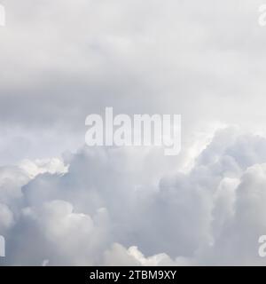 Cloudy sky background with sunlight shining through white clouds. Natural backdrop Stock Photo