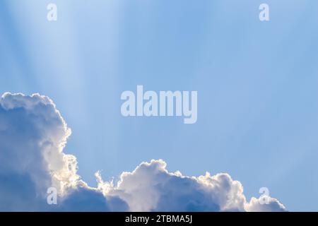 Background from blue sky with sun rays across clouds. High quality photo Stock Photo
