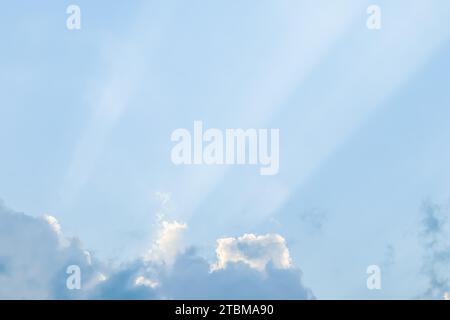 Background from blue sky with sun rays across clouds. High quality photo Stock Photo