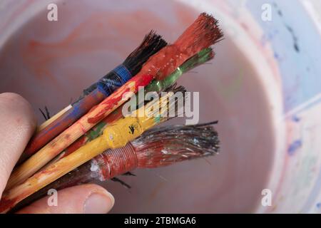 Paint brushes on technique ebru art on wooden background Stock Photo