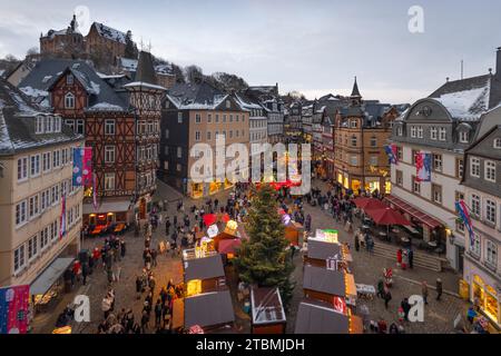 The lights at the Christmas market in Marburg's old town centre begin to glow in the evening, Wetterau, Marburg, Hesse, Germany Stock Photo