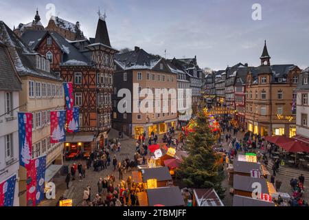 The lights at the Christmas market in Marburg's old town centre begin to glow in the evening, Wetterau, Marburg, Hesse, Germany Stock Photo