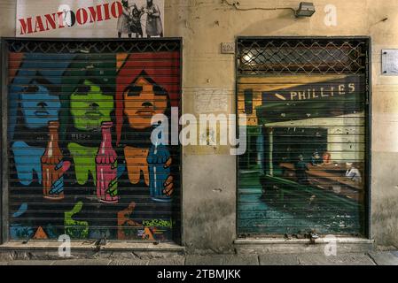 Paintings on closed shop blinds in the old town centre, Genoa, Italy Stock Photo