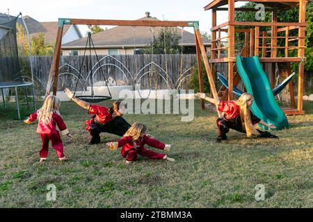 Fort Worth, USA. 18th Nov, 2023. David Saucedo (2nd L) and his wife Angela Saucedo (1st R) practice Wushu with their children at the backyard of their home, in Fort Worth, Texas, the United States, Nov. 18, 2023. TO GO WITH 'Feature: Love journey of U.S. Wushu family' Credit: Tian Dan/Xinhua/Alamy Live News Stock Photo