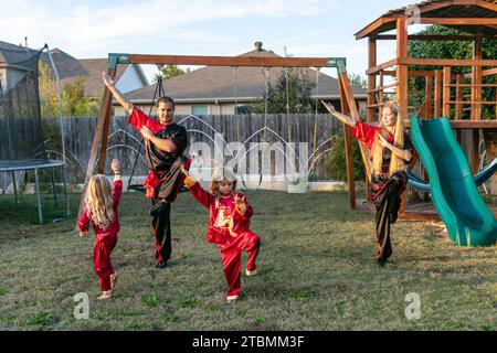 Fort Worth, USA. 18th Nov, 2023. David Saucedo (2nd L) and his wife Angela Saucedo (1st R) practice Wushu with their children at the backyard of their home, in Fort Worth, Texas, the United States, Nov. 18, 2023. TO GO WITH 'Feature: Love journey of U.S. Wushu family' Credit: Tian Dan/Xinhua/Alamy Live News Stock Photo