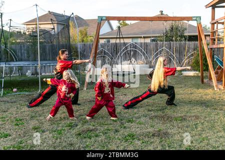 Fort Worth, USA. 18th Nov, 2023. David Saucedo (1st L) and his wife Angela Saucedo (1st R) practice Wushu with their children at the backyard of their home, in Fort Worth, Texas, the United States, Nov. 18, 2023. TO GO WITH 'Feature: Love journey of U.S. Wushu family' Credit: Tian Dan/Xinhua/Alamy Live News Stock Photo