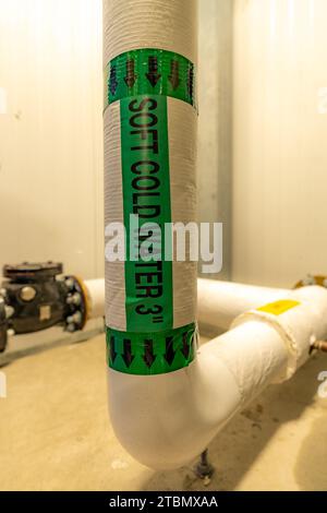 The interior of a mechanical room and a domestic potable water system with valves and connecting pipes. Stock Photo