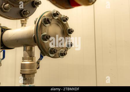 The interior of a mechanical room and a domestic potable water system with valves and connecting pipes. Stock Photo