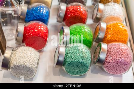 Colored polymer granules in glass Stock Photo