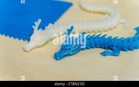 3D printer printing dragon head figure close-up. Stock Photo
