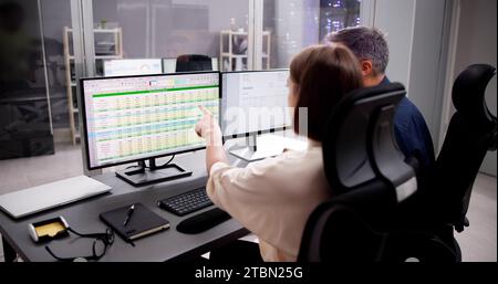 Working Analyst at Desktop Computer with Spreadsheet Spreadsheets Stock Photo