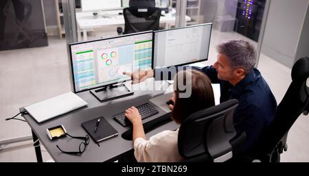 Medical Coder Working on Multiple Spreadsheets with Computer Stock Photo