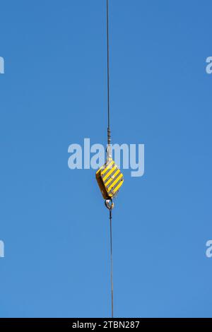 crane steel hook with cable on blue sky,Industrial equipment or tools. Stock Photo
