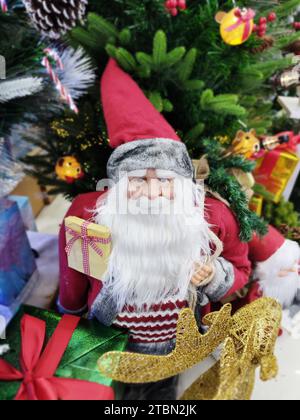 Cute Santa Claus doll with gifts. Happy New Year and merry Christmas Stock Photo