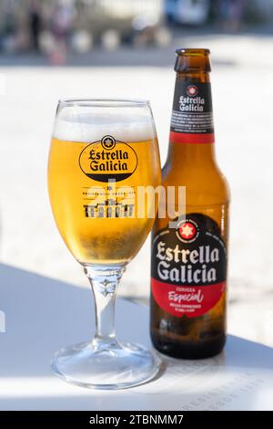 Estrella Galicia Spanish beer in glass and bottle, Spain Stock Photo
