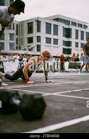 Woman doing burpee at a CrossFit competition. Stock Photo