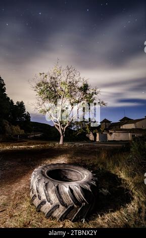 Abandoned tractor wheel in the Sella forest Stock Photo