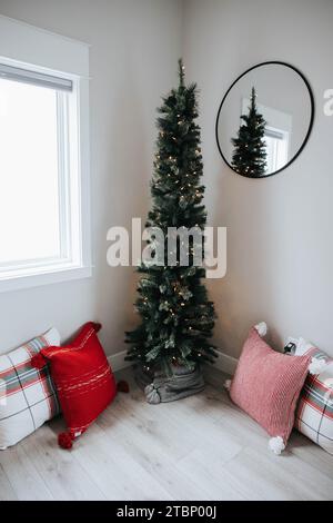 Cozy house with Christmas tree and pillows Stock Photo