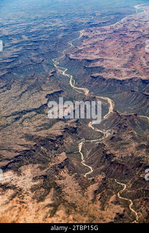 Winding Riger Aerial view of winding dry river channels carved across textured desert ...