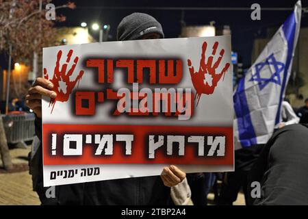 A right-wing activist holds a sign that reads 'Release of terrorists is bloodbath' during a protest dubbed the 'March of the Maccabees' outside Jerusalem Old City on December 7, 2023 in Jerusalem. The protest was organized to memorialize victims of the Israel-Hamas war, while also demanding that the entirety of Jerusalem, including the Temple Mount/Al-Aqsa Mosque compound, be placed under Jewish control. Stock Photo