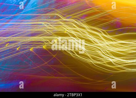 An abstract picture of light streaks on a dark blue purple background Stock Photo
