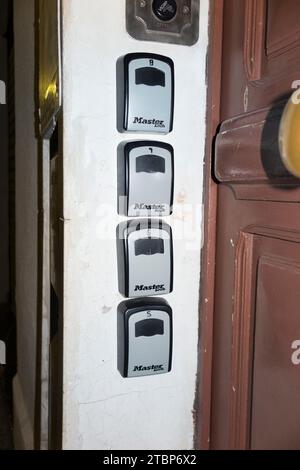 Series of Master Lock wall mounted key box / boxes / combination key safe / safes on building wall. Short let Airbnb guests & visitors often stay (135) Stock Photo