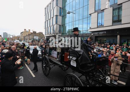 The funeral procession of Shane MacGowan on Pearse Street makes its way through the streets of Dublin ahead of his funeral in Co Tipperary. The songwriter, who found fame as the lead singer of London-Irish punk/folk band The Pogues, died at the age of 65 last week. Picture date: Friday December 8, 2023. Stock Photo