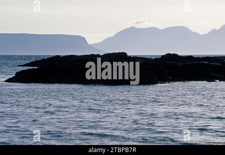 The isles of Eigg and Rum viewed from the beach at Arisaig Lochaber Scotland Stock Photo